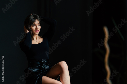dramatic portraits with sensual brunette woman posing in the dark