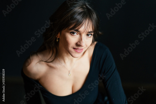 dramatic portraits with sensual brunette woman posing in the dark