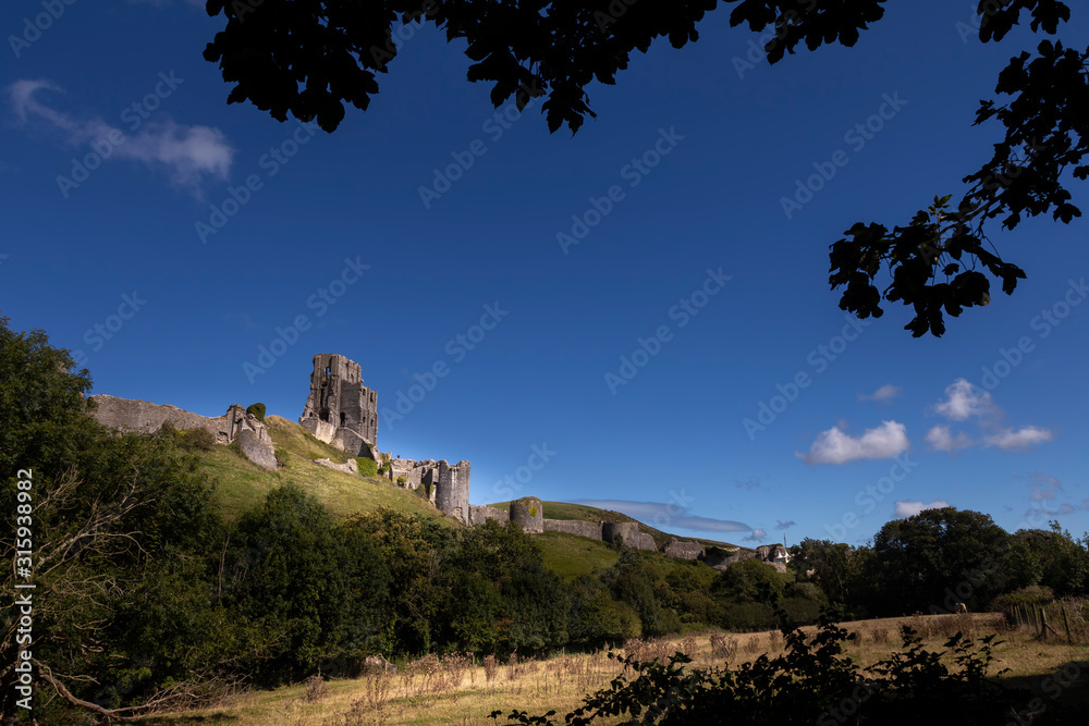 Corfe Castle sitting atop a hill