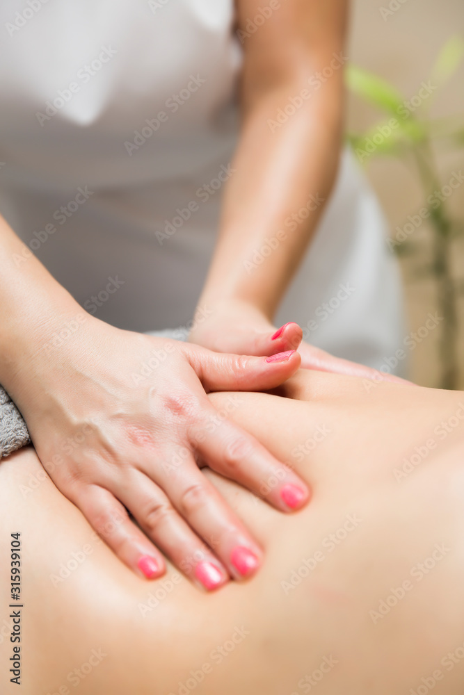 Woman having an professional massage of the abdomen Woman having an professional massage of the abdomen