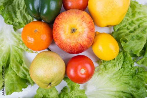 Close up of healthy bio food on the table. Organic fruits and vegetables from the farm garden. Bunch of fresh crop, no genetically modified cuisine. Vegan and vegetarian nutrition.