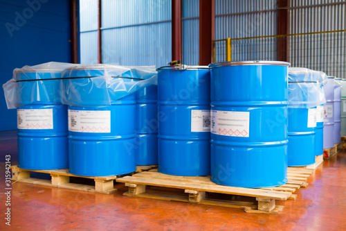 Blue metal cans with paint in production.