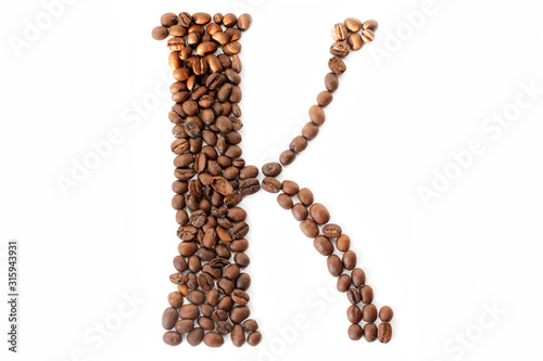 Coffee beans. Letter K made from coffee beans on a white background. Brown