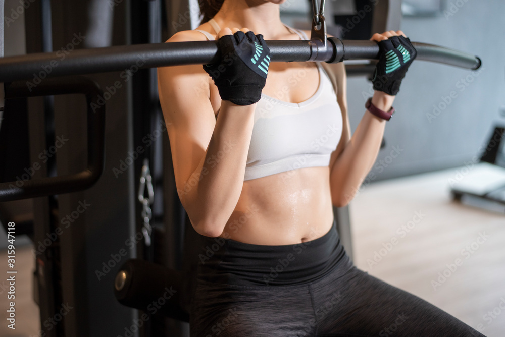 Beautiful asian woman is doing exercise in the gym Beautiful asian woman is doing exercise in the gym
