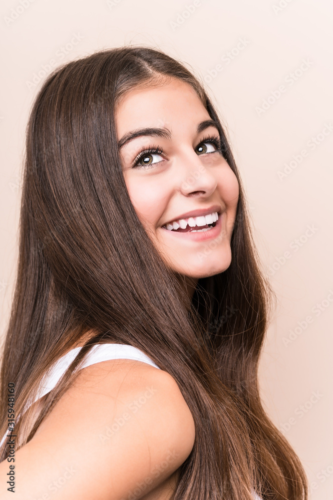 Fototapeta premium Young cute caucasian woman against a beige background