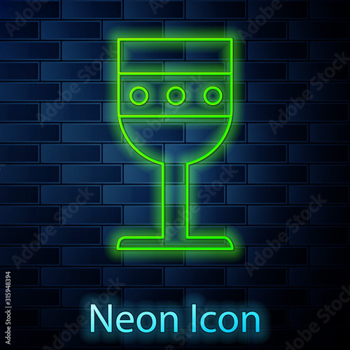 Glowing neon line Medieval goblet icon isolated on brick wall background. Vector Illustration