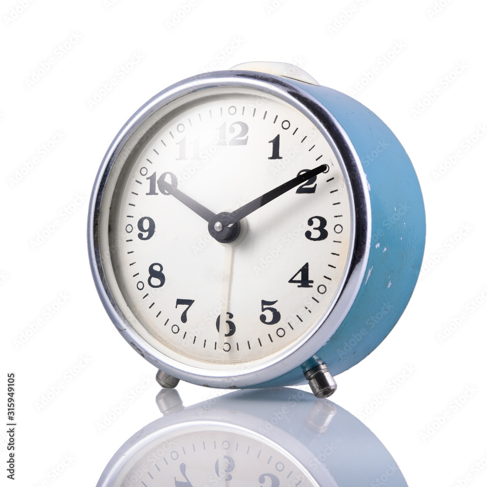 Blue retro alarm clock on a white isolated background, close-up.