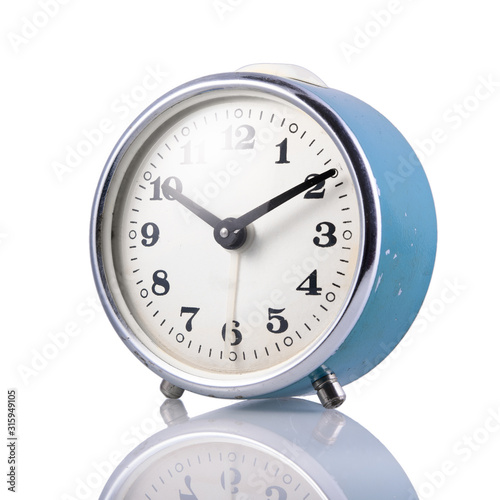 Blue retro alarm clock on a white isolated background, close-up.