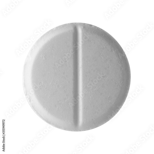 White round pill on a white isolated background. Big pill close-up.