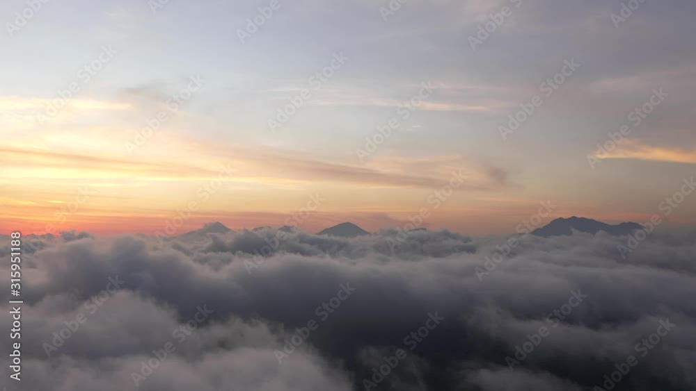 Majestic sunset above clouds over the mountain.Colorful clear sky during the sunset. Majestic sunset above clouds over the mountain.Colorful clear sky during the sunset.