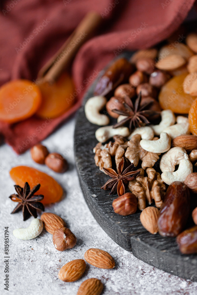 Natural healthy and delicious vegan dessert. Concept of sweet, low calories and tasty snack. Dry fruits and spices. Wooden dark rustic board, neutral background. Close up, macro 