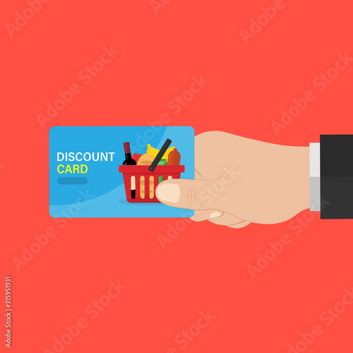 hand holds a discount card for shopping products in the store, a basket of products.