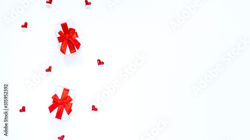 Valentines Day banner with hearts and white and red gift boxes isolated on white backdrop. Copy space. Romantic festive template concept for greeting card  advertising. Women   s day. Place for text.