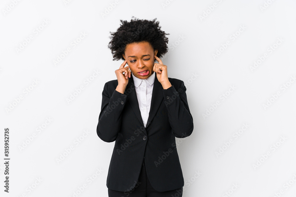 Middle aged african american business woman against a white background isolated covering ears with hands. Middle aged african american business woman against a white background isolated covering ears with hands.