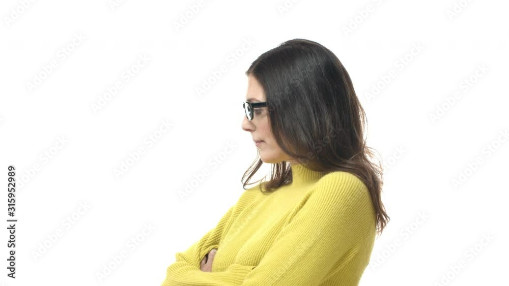 Slow-motion adult, middle-aged woman in glasses, wife acting silly and moody, pouting, turn-away from person having argument, cross hands over chest offended, standing white background Slow-motion adult, middle-aged woman in glasses, wife acting silly and moody, pouting, turn-away from person having argument, cross hands over chest offended, standing white background