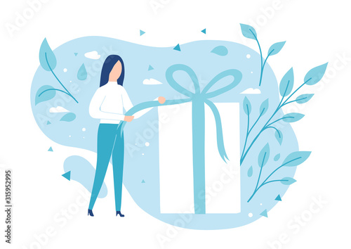 The girl opens a gift. Pulling a ribbon to untie a bow on a gift box