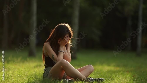 Millennial woman feeling regret rememebering traumatic event, feeling hopeless photo