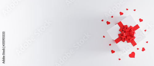 White gift box with red ribbon bow on white background with heart confetti. Christmas present, valentine day surprise, birthday concept. Flat lay, top view. Present concept