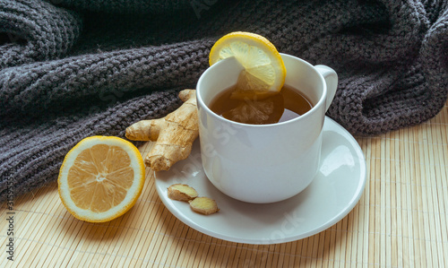 Ginger tea with sliced lemon on the cup on bamboo stand