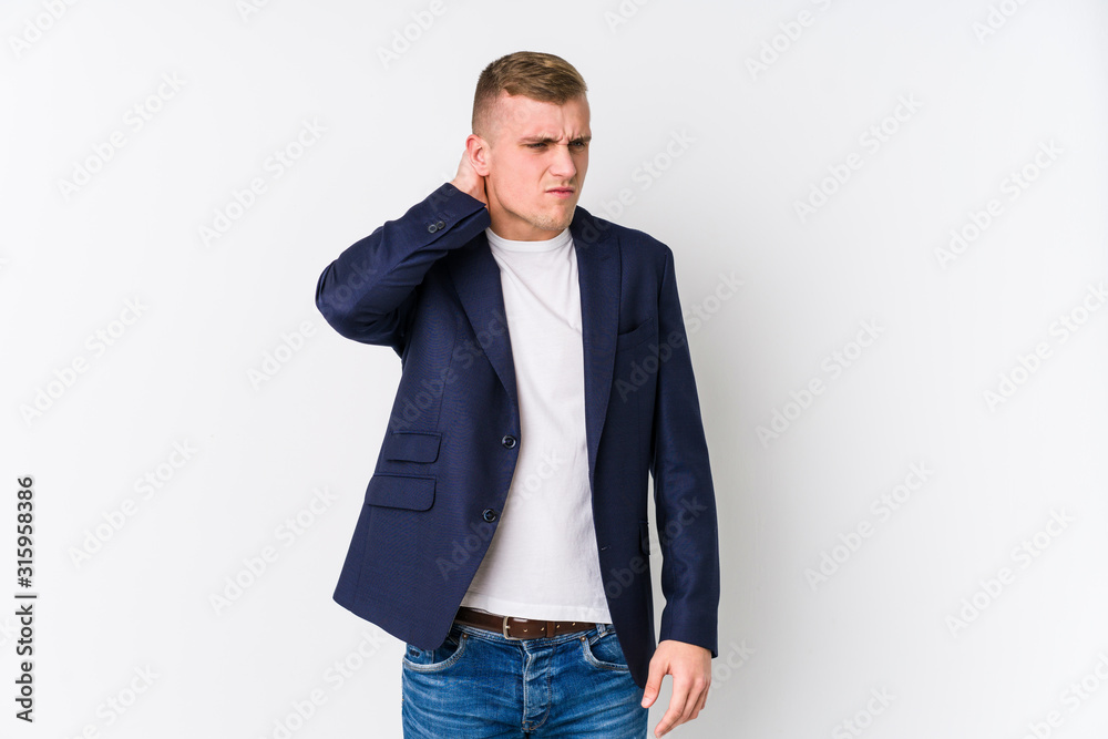 Young business caucasian man suffering neck pain due to sedentary lifestyle. Young business caucasian man suffering neck pain due to sedentary lifestyle.