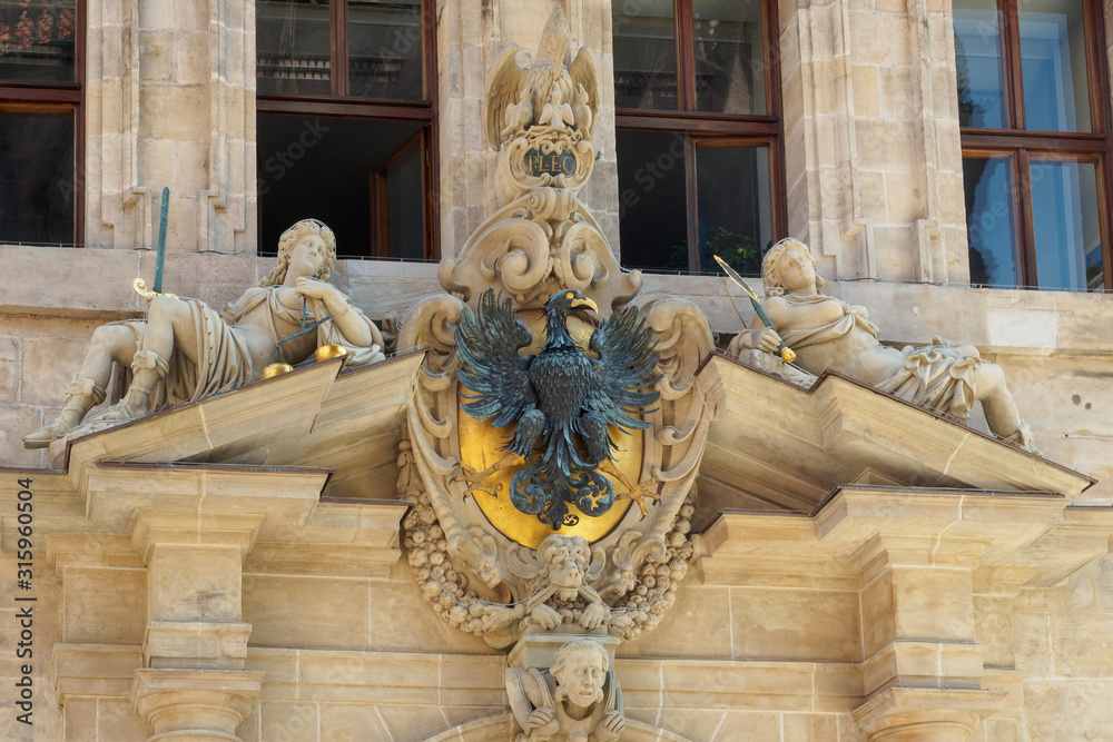 Coat of arms with eagle and sculptures over entrance of the old town hall in Nuremberg, Bavaria, Germany