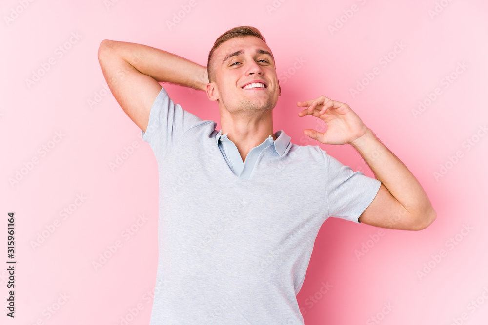 Young caucasian man isolated stretching arms, relaxed position. Young caucasian man isolated stretching arms, relaxed position.