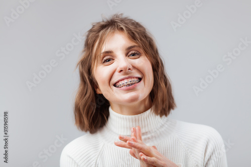Young beautiful woman with dental braces on her teeth