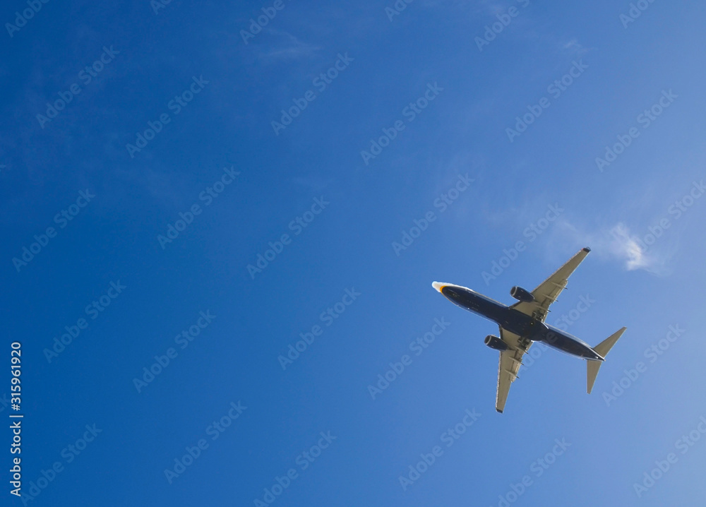 Passenger airplane on a blue sky white clouds background.Leaving flight.Selective soft focus. Passenger airplane on a blue sky white clouds background.Leaving flight.Selective soft focus.