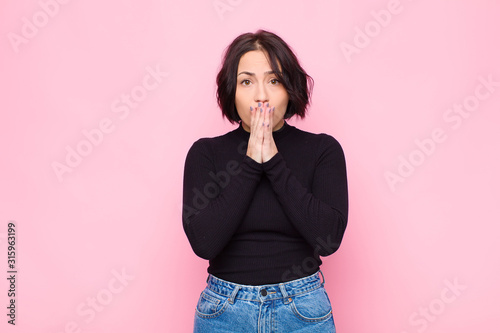 Cuadro en lienzo young pretty woman feeling worried, upset and scared, covering mouth with hands,