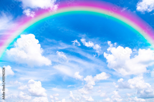 White clouds in blue sky with sunlight and rainbow  the beautiful sky with clouds have copy space for the background.