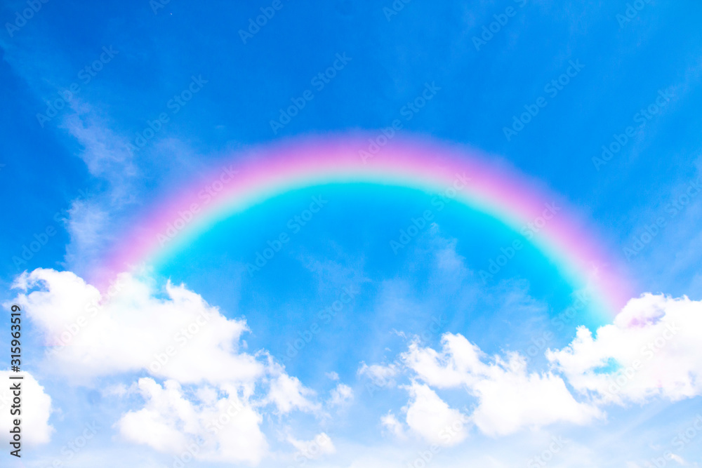 White clouds in blue sky with sunlight and rainbow, the beautiful sky with clouds have copy space for the background.