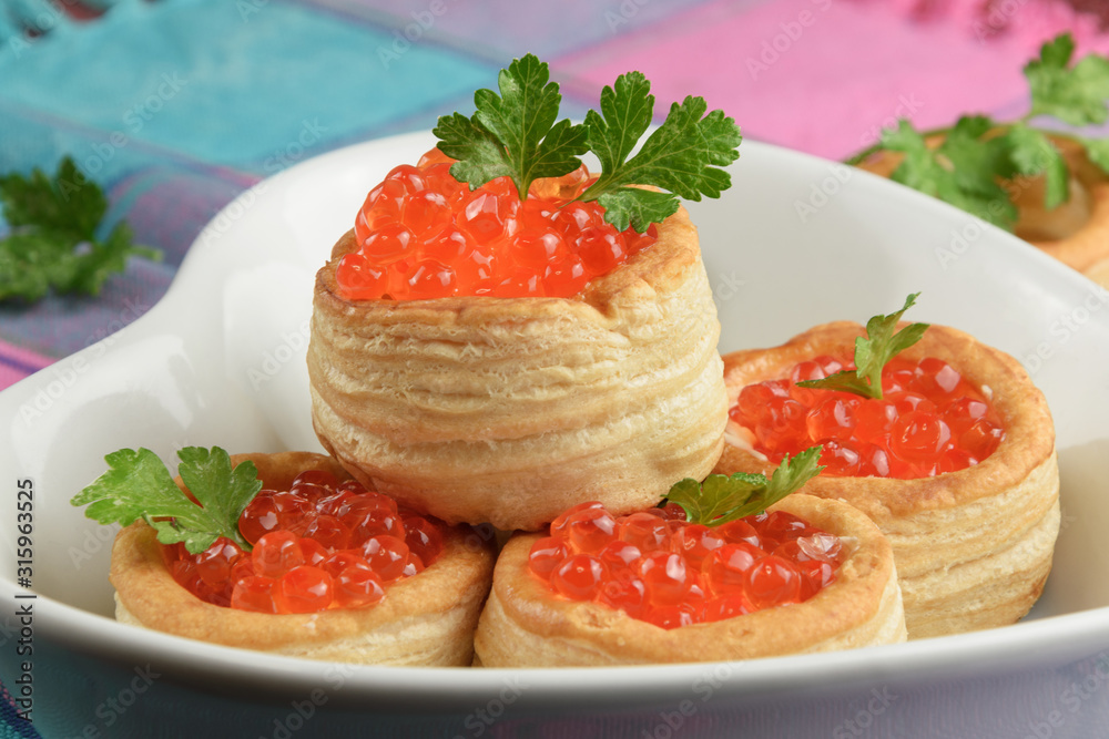 4 tartlets with red caviar decorated with parsley 4 tartlets with red caviar decorated with parsley