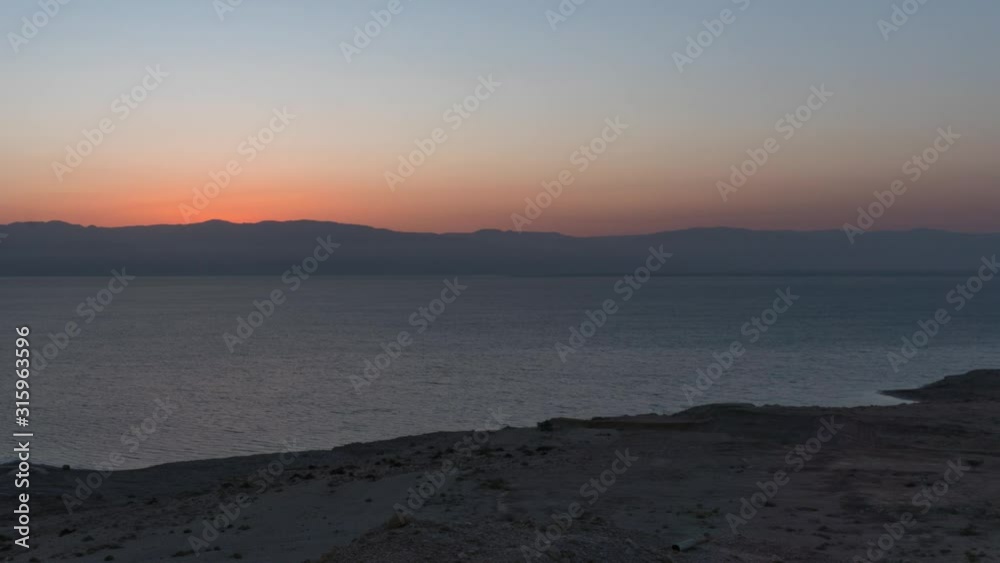 Sunrise time lapse over seaside cliffs and ocean, off-centre left Sunrise time lapse over seaside cliffs and ocean, off-centre left