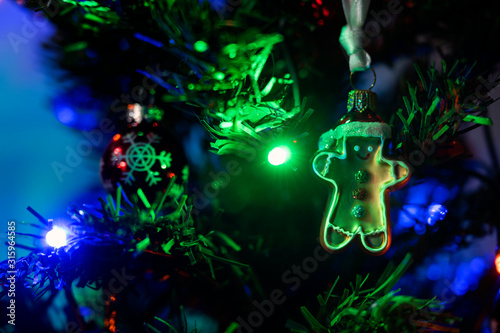 Ceramic gingerbread figurine hanging on a Christmas tree.