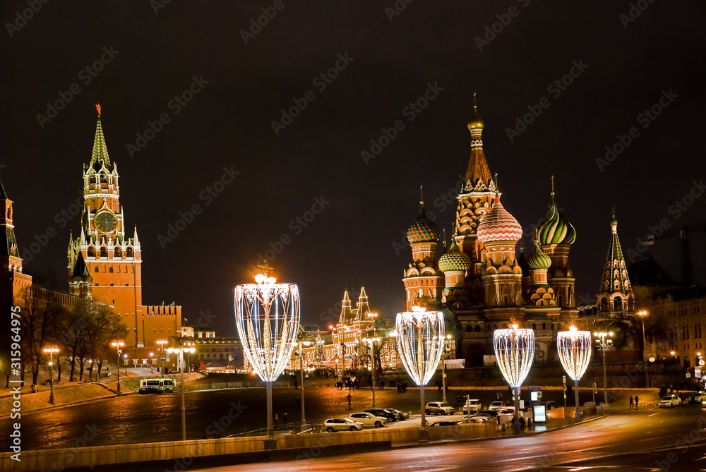 View of the Spasskaya Tower of the Kremlin and St. Basil's Cathedral from Moskvoretsky bridge at night