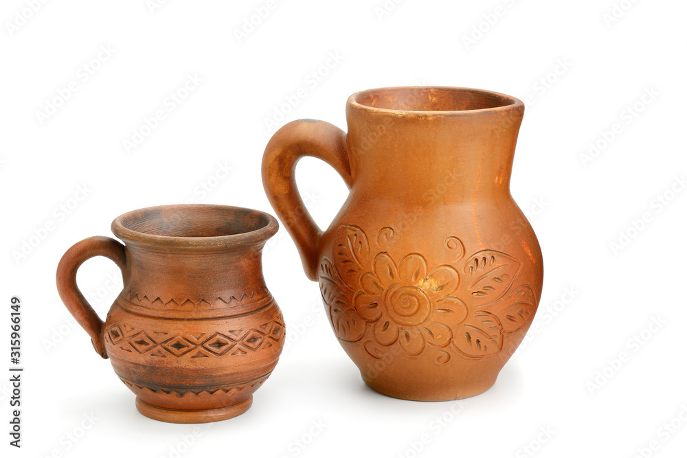 Clay jug and mug isolated on a white background.