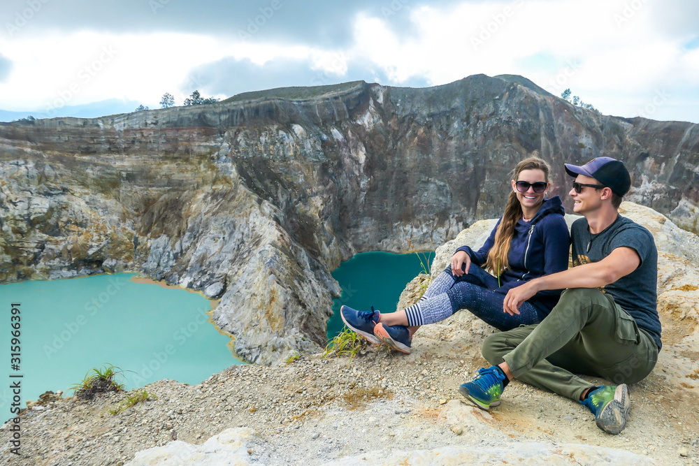 Fototapeta premium Kelimutu - A couple admiring turquoise coloured volcanic lakes