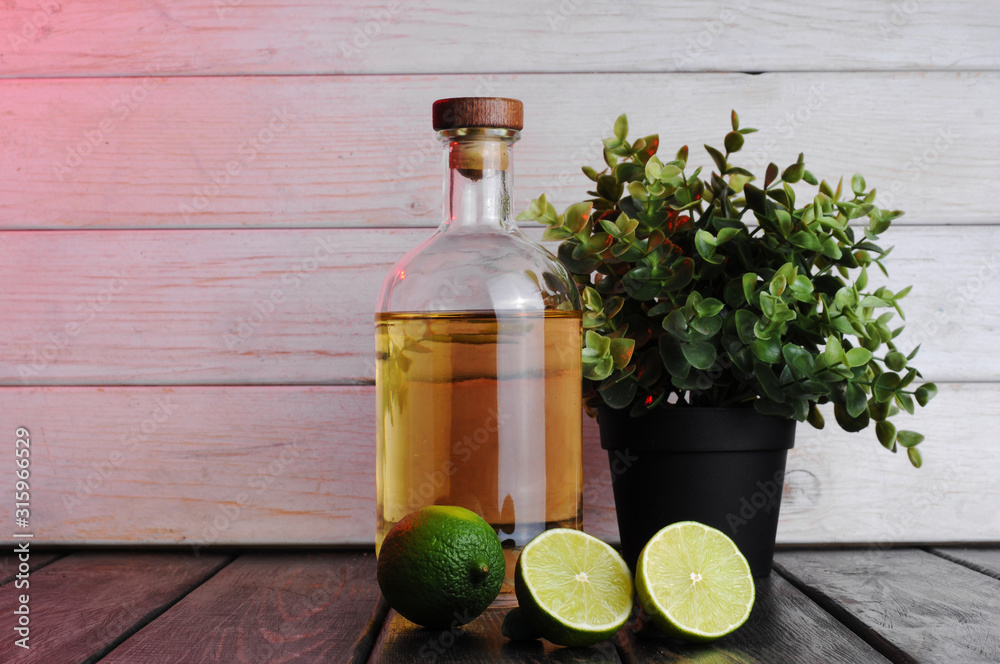 Bottle of whiskey on a wooden background.Studio photography Bottle of whiskey on a wooden background.Studio photography