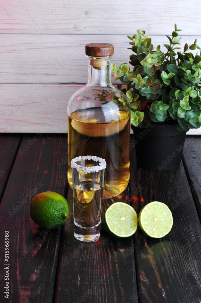 Bottle of whiskey on a wooden background.Studio photography Bottle of whiskey on a wooden background.Studio photography