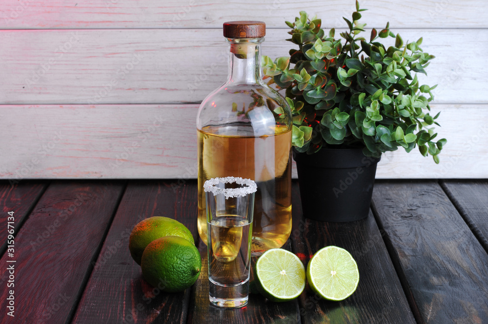 Bottle of whiskey on a wooden background.Studio photography Bottle of whiskey on a wooden background.Studio photography