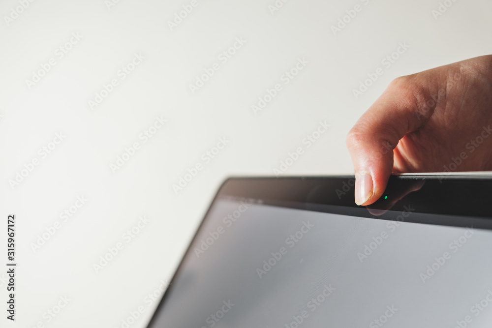 Thumb covers up the webcam of a computer. Concept of privacy, online security of a firewall Thumb covers up the webcam of a computer. Concept of privacy, online security of a firewall