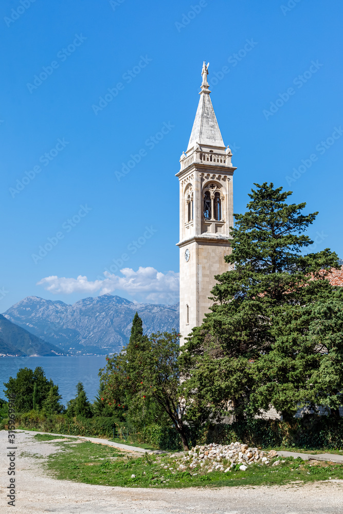 Beautiful view of the St.Eustace's Church in the village Dobrota at the coast of Kotor Bay in Montenegro. Vertical photo.