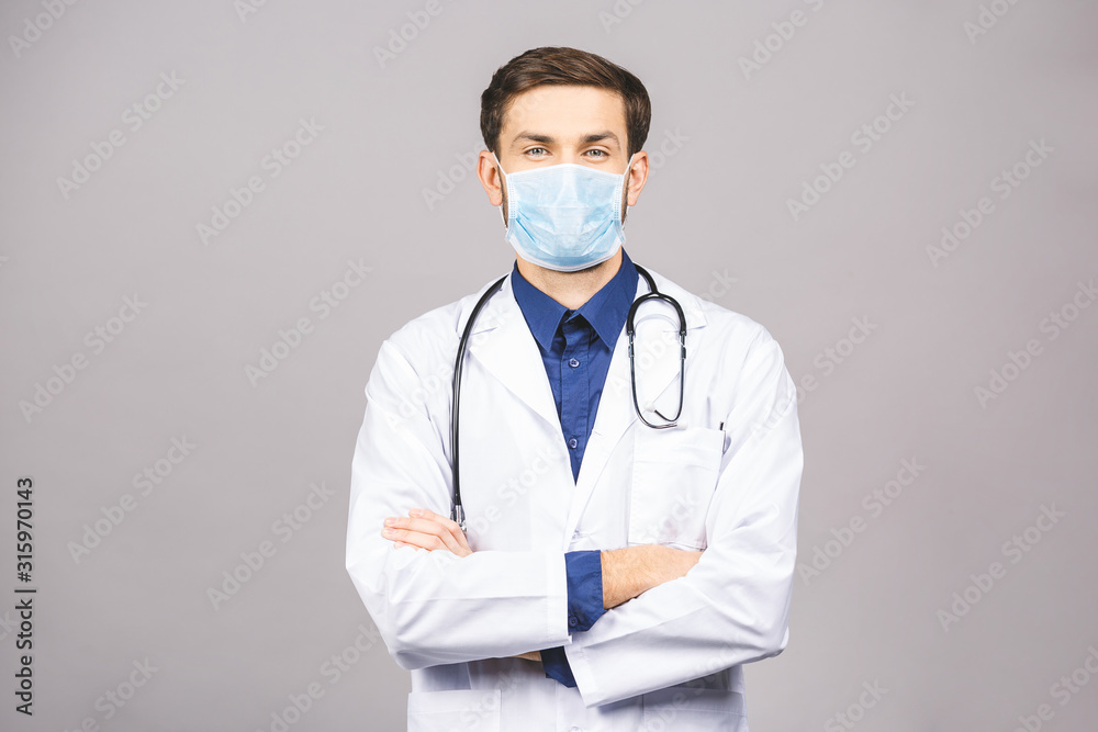 Portrait of young doctor in mask isolated on grey background. Portrait of young doctor in mask isolated on grey background.