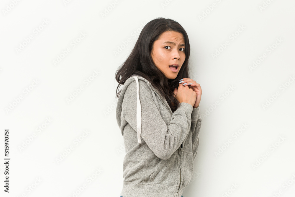 Young fitness chinese woman scared and afraid. Young fitness chinese woman scared and afraid.