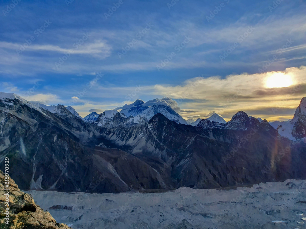 Everest and Nuptse in clouds. Picturesque mountain view from Gokyo Ri at sunrise. Trekking in Solokhumbu, Nepal, Himalayas.