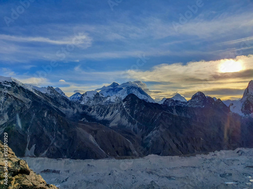 Everest and Nuptse in clouds. Picturesque mountain view from Gokyo Ri at sunrise. Trekking in Solokhumbu, Nepal, Himalayas.