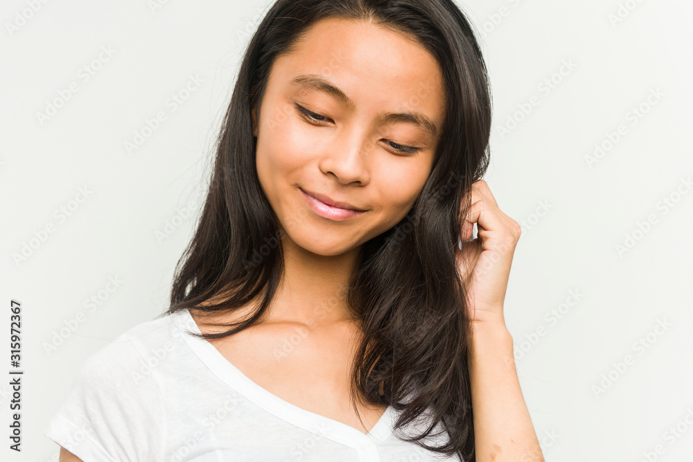Young chinese woman posing on a white background Young chinese woman posing on a white background