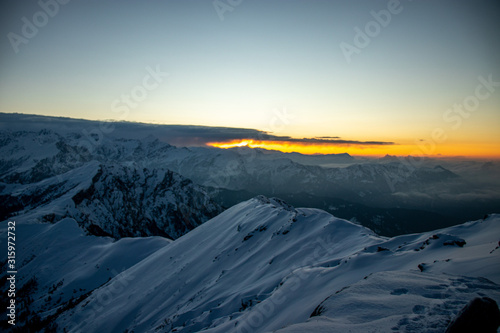 A beautiful view of a sunrise and himalayan mountains from the summit of a himalayan mountain