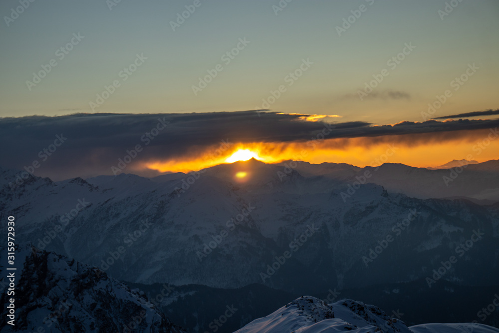A beautiful view of a sunrise and himalayan mountains from the summit of a himalayan mountain