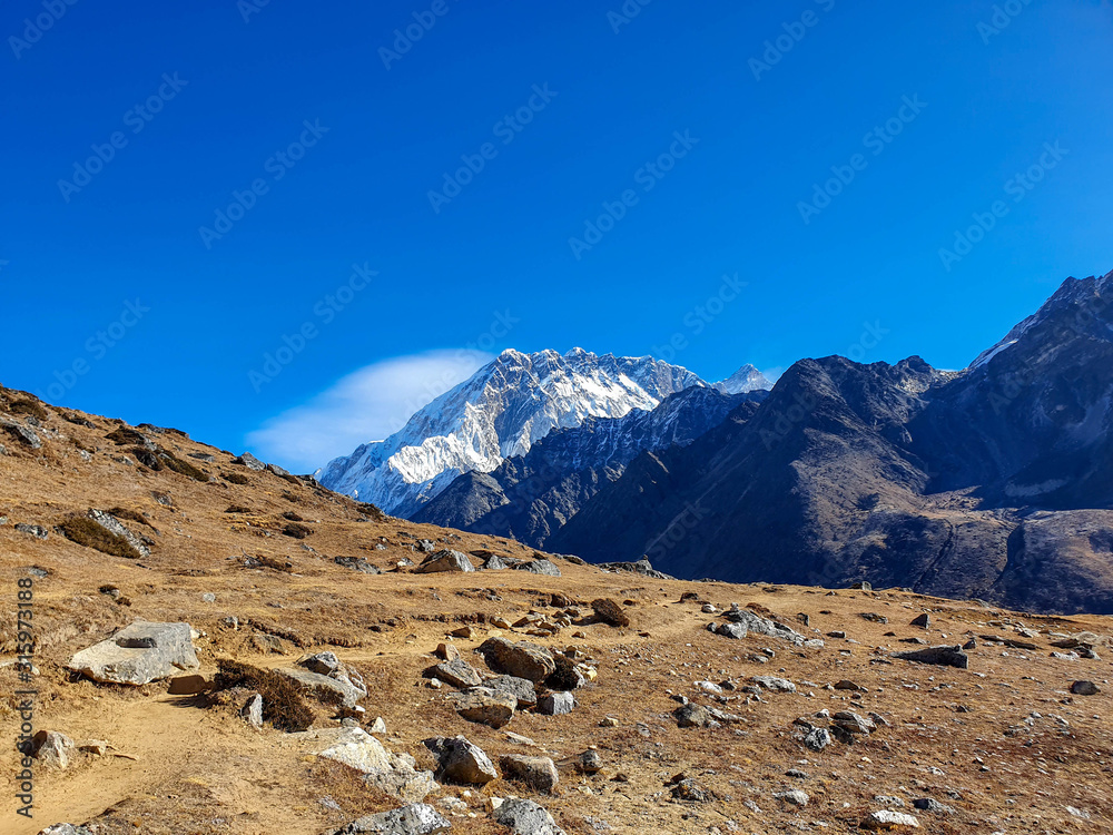 Beautiful view on Nuptse mountain in the early sunny morning. Everest base camp trek: from Dzongla to Lobuche, Solokhumbu, Nepal.